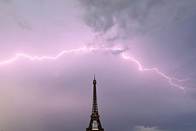 A lightning strikes is seen close to the Eiffel tower prior the men's 20km race walk of the athletics event at the Paris 2024 Olympic Games at Trocadero in Paris on August 1, 2024. (Photo by Loic Venance/AFP Photo)