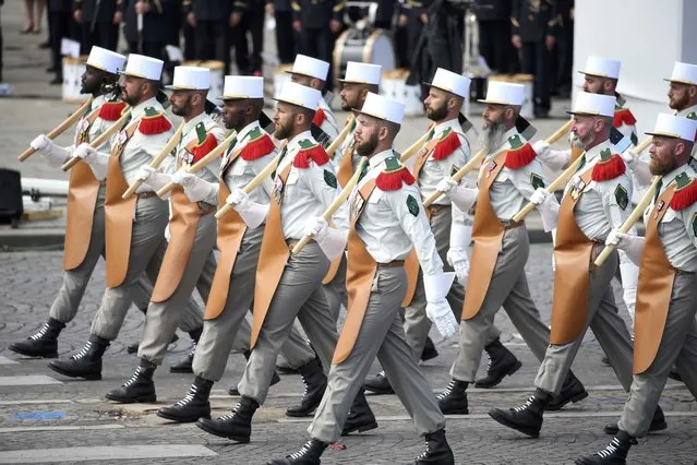 Pioneers of the 1st Foreign Legion regiment carry their axes as they march during the traditional Bastille Day military parade on the Place de la Concorde in Paris, France, July 14, 2016. (Photo by Charles Platiau/Reuters)