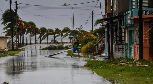 Cubans retrieve their belongings after the passage of Hurricane Irma in Caibarien, Villa Clara province, 330 km east of Havana, on September 9, 2017. Irma' s blast through the Cuban coastline weakened the storm to a Category Three, but it is still packing 125 mile- an- hour winds (205 kilometer per hour) and was expected to regain power before hitting the Florida Keys early Sunday, US forecasters said. The Cuban government extended its maximum state of alert to three additional provinces, including Havana, amid fears of flooding in low- lying areas. (Photo by Adalberto Roque/AFP Photo)