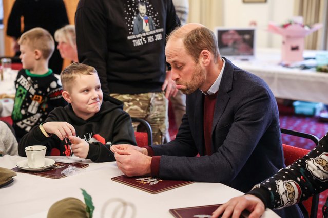 The Prince of Wales, Colonel-in-Chief of the 1st Battalion Mercian Regiment, examines a picture of him drawn bt 10 year old Karson Heighway during a visit to the Regiment for a Christmas event with the soldiers and families at Picton Barracks in Wiltshire on December 10, 2024. (Photo by Richard Pohle/The Times)