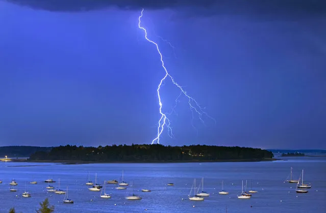 In this photo made Wednesday, September 11, 2013, lightning strikes north of Macworth Island in Portland, Maine. (Photo by Robert F. Bukaty/AP Photo)