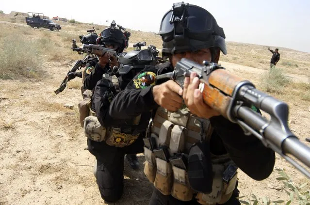 Iraqi special police officers demonstrate their skills during a graduation ceremony in Kerbala August 28, 2014. (Photo by Mushtaq Muhammed/Reuters)
