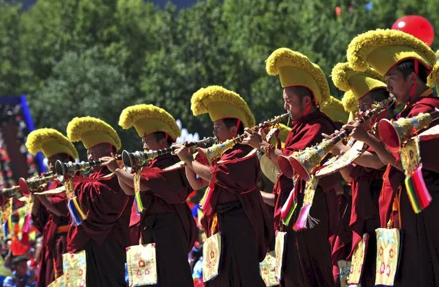 Tibetan monks play horns during the celebration event at the Potala Palace marking the 50th anniversary of the founding of the Tibet Autonomous Region, in Lhasa, Tibet Autonomous Region, China, September 8, 2015. (Photo by Reuters/China Daily)