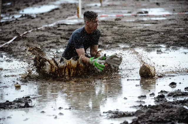 Contestant compete during the 8th mud soccer championship on August 6, 2016 in Woellnau near Leipzig, Germany. Legend has it that a Finnish officer sent his soldiers to the bog for condition runs. To increase the fun factor, one day he kicked a ball onto the marsh and mud football was born. The championships have been held since 1998 and in 2000 a World Championships with international teams was created. (Photo by Jens Schlueter/Getty Images)