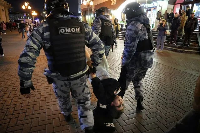 Riot police detain a demonstrator during a protest against mobilization in Moscow, Russia, Wednesday, September 21, 2022. Russian President Vladimir Putin has ordered a partial mobilization of reservists in Russia, effective immediately. He risks a deeply unpopular step that follows humiliating setbacks for his troops nearly seven months after invading Ukraine. (Photo by Alexander Zemlianichenko/AP Photo)