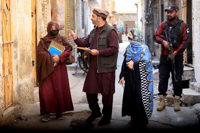 A police officer and health workers visit homes during a door-to-door vaccination campaign in Peshawar, KPK province, Pakistan, 03 February 2025. A police officer was killed on Monday in Jamrud, Khyber Pakhtunkhwa, while securing a polio vaccination campaign. He was attacked by two assailants on a motorcycle, underscoring security challenges for health workers in Pakistan. Prime Minister Shehbaz Sharif recently launched a nationwide anti-polio drive aimed at vaccinating millions of children, reaffirming the nation's commitment to eradicating polio, a disease that has resurged in volatile regions despite a 99 percent reduction in cases since 1994. The World Health Organization continues to support Pakistan's efforts toward the final stages of polio eradication, emphasizing the need to secure vaccination teams in targeted areas. (Photo by Bilawal Arbab/EPA/EFE)
