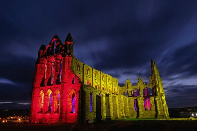 A light display illuminates the ruins of the historic Whitby Abbey on October 24, 2017 in Whitby, England. The famous Benedictine abbey was the inspiration for Bram Stoker's gothic novel Dracula and will be illuminated during the English Heritage event over seven nights during Halloween and the Half Term period to celebrate that history. (Photo by Ian Forsyth/Getty Images)