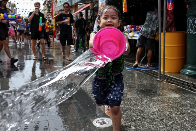 A girl plays with water as she celebrates the Songkran holiday, which marks the Thai New Year, in Bangkok, Thailand, on April 12, 2025. (Photo by Chalinee Thirasupa/Reuters)