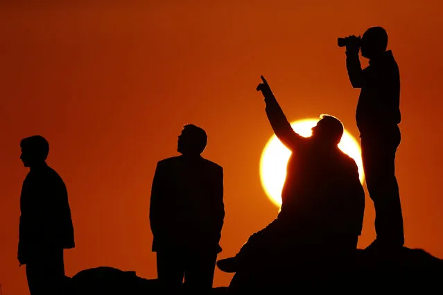 Turkish Kurds watch the Syrian town of Kobani from near the Mursitpinar border crossing, on the Turkish-Syrian border in the southeastern town of Suruc in Sanliurfa province, October 18, 2014. (Photo by Kai Pfaffenbach/Reuters)