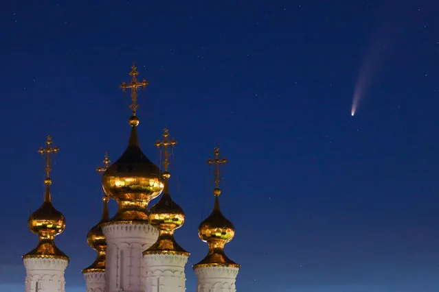 Comet NEOWISE streaks across the night sky over the Epiphany Church of the Transfiguration Monastery in Ryazan, Russia on July 13, 2020. The retrograde comet C/2020 F3 (NEOWISE) was discovered on March 27, 2020, using the NEOWISE infrared space telescope. (Photo by Alexander Ryumin/TASS)