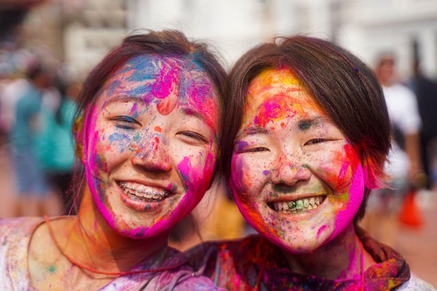 Tourist revelers with vermillion colors on their face as they celebrates Fagu Purnima also known as “Holi” or the carnival of colors in Kathmandu, Nepal on March 13, 2025. (Photo by Sujal Bajracharya/ZUMA Press Wire/Alamy Live News)