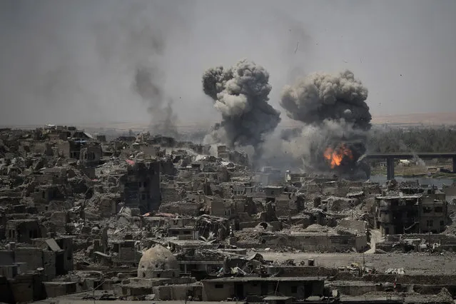 Airstrikes target Islamic State positions on the edge of the old city of Mosul, Iraq, on July 11, 2017, a day after Iraq's prime minister declared “total victory” there. (Photo by Felipe Dana/AP Photo)