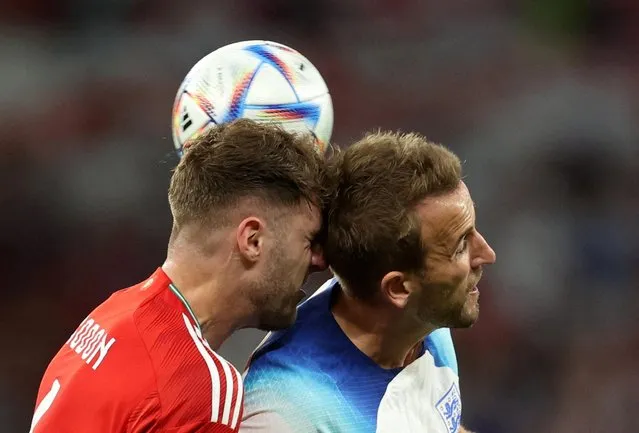 England's forward #09 Harry Kane (R) fights for the ball with Wales' defender #06 Joe Rodon during the Qatar 2022 World Cup Group B football match between Wales and England at the Ahmad Bin Ali Stadium in Al-Rayyan, west of Doha on November 29, 2022. (Photo by Carl Recine/Reuters)