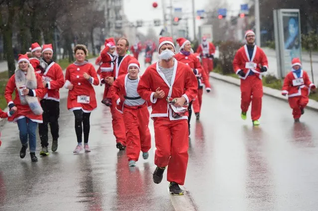 Runners dressed as Santa Claus take part in a charity race in Pristina, on December 17, 2017, to raise funds for families in need in Kosovo. (Photo by Armend Nimani/AFP Photo)