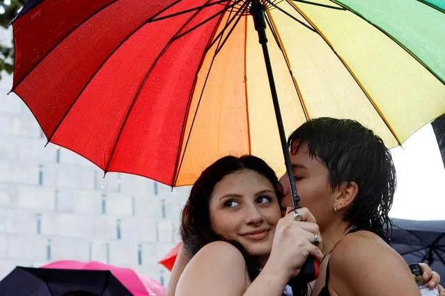 Mateo Esquivel kisses Anna Gregoriani as they take part in the first Transgender Pride, organized by LGBT community, in San Jose, Costa Rica on October 16, 2022. (Photo by Mayela Lopez/Reuters)