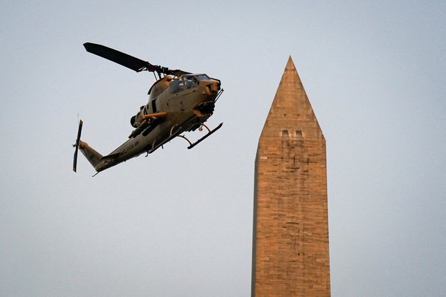 A Bell AH-1 Cobra attack helicopter, slated to be used in the U.S. Army's 250th Birthday Celebration and Parade, flies past the Washington Monument on the National Mall in Washington, D.C., on June 11, 2025. (Photo by Al Drago/Reuters)