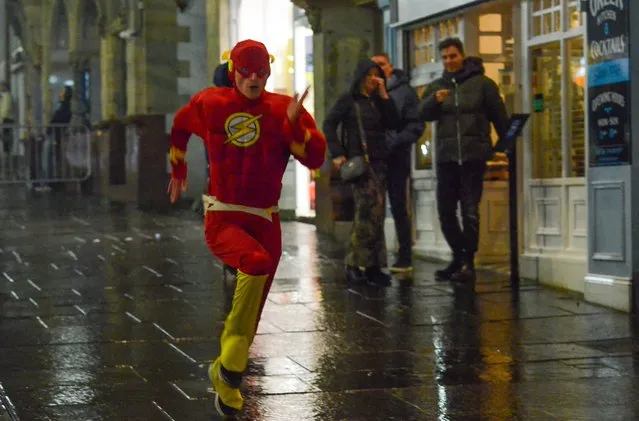 This bloke in Newcastle, United Kingdom decided to dress up as a festive version of The Flash on December 23, 2022. Brits braved the rain for a festive blowout on Friday to kick off the Christmas celebrations. (Photo by NNP Photography)