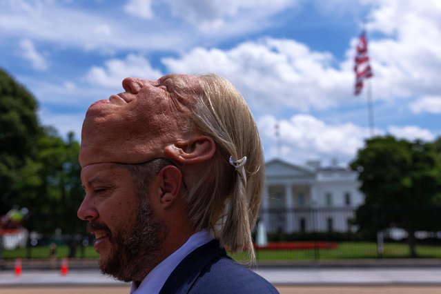 A man wearing a latex mask depicting U.S. President Donald Trump stands outside the White House, in Washington, D.C., U.S., June 19, 2025. (Photo by Carlos Barria/Reuters)