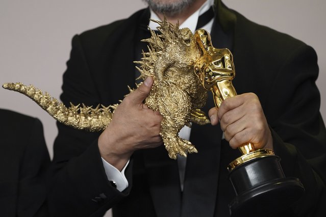 Japanese filmmaker and visual effects supervisor Takashi Yamazaki poses a Godzilla figurine with the award for best visual effects for “Godzilla Minus One” at the Oscars on Sunday, March 10, 2024, at the Dolby Theatre in Los Angeles. (Photo by Jordan Strauss/Invision/AP Photo)