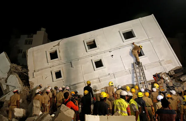 Police and rescue workers look for survivors amidst the rubble at the site of a collapsed under-construction building in Bengaluru, India, February 15, 2018. (Photo by Abhishek N. Chinnappa/Reuters)