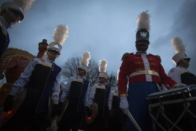 A marching band takes part in a practice session as the sun rises before the Macy's Thanksgiving Day Parade in New York, November 27, 2014. (Photo by Carlo Allegri/Reuters)