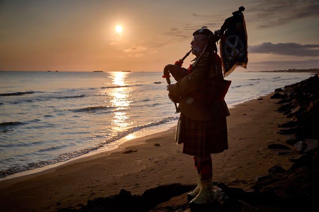 Lone Piper Yves Holbecq from the Somme Battlefield Pipe Band plays at sunrise to mark the 81st anniversary of the D-Day landings on Gold Beach on June 06, 2025 in Arromanches-les-Bains, Normandy, France. Today marks the 81st Anniversary of 'Operation Overlord', the Allied invasion of Normandy during World War II that led to the liberation of Western Europe and eventual defeat of Nazi Germany. (Photo by Kiran Ridley/Getty Images)