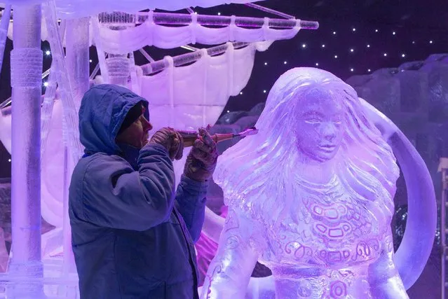 Sculptor Jiri Genzer of the Czech Republic carves an ice sculpture at the Disney Dreams Ice Festival in Antwerp November 27, 2014. Some 60 artists from all over the world participated in the festival, making sculptures out of around 500 tonnes of ice. The festival will open on November 29 until January 11, 2015. (Photo by Yves Herman/Reuters)