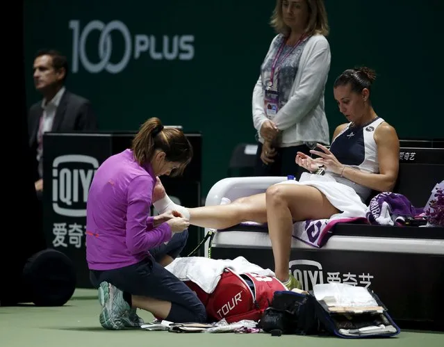 Flavia Pennetta of Italy receives medical attention during her women's singles tennis match against Agnieszka Radswanka of Poland of the WTA Finals at the Singapore Indoor Stadium October 27, 2015. (Photo by Edgar Su/Reuters)