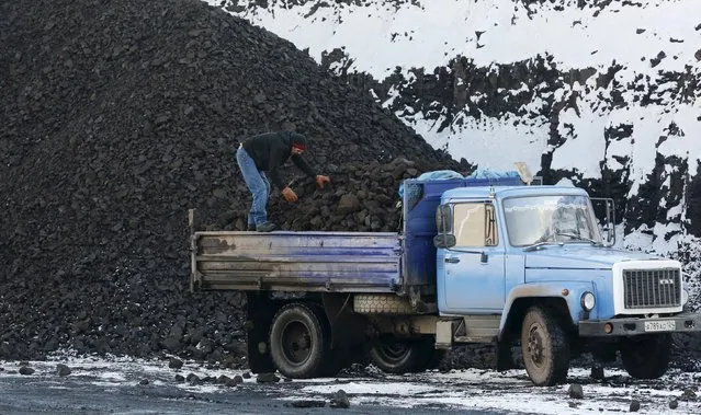 A driver loads coal for sale onto a truck from a coal dump site at the Borodinsky opencast colliery near the Siberian town of Borodino, east of Krasnoyarsk, Russia October 27, 2015. (Photo by Ilya Naymushin/Reuters)