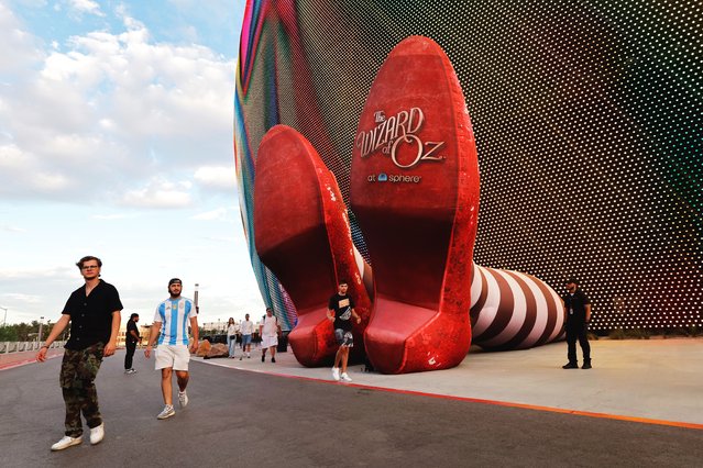 People pass by a display of 50-feet-long legs and 22-feet-tall ruby slippers, a promotion for the upcoming “Wizard of Oz at Sphere” movie in Las Vegas, Nevada, U.S., August 20, 2025. (Photo by Steve Marcus/Reuters)