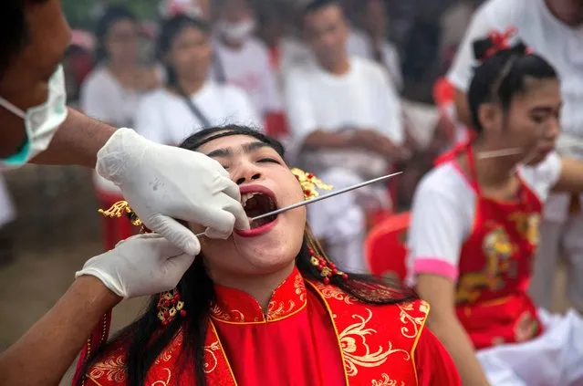 Thai devotees are possessed by spirits and pierced with long needles during a Vegetarian ritual at the Sapam Shrine on October 19, 2020 in Phuket, Thailand. (Photo by Lauren DeCicca/Getty Images)