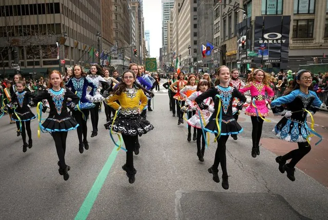 Young girls from the Irish Dancing and Music Association of America dance during the annual Saint Patrick's Day parade on 5th Avenue in Manhattan in New York City, New York, U.S., March 17, 2023. (Photo by Mike Segar/Reuters)