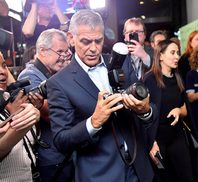 George Clooney borrows a photographer’s camera at the premiere of “Jay Kelly” at the city’s film festival in New York City on September 29, 2025. (Photo by Stephen Lovekin/Rex Features/Shutterstock)