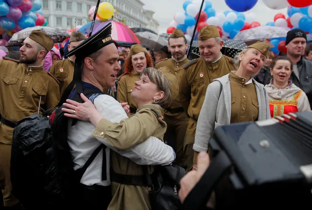 A couple dressed in historical military uniforms dances during May Day celebrations in central Moscow, Russia on May 1, 2018. (Photo by Maxim Shemetov/Reuters)
