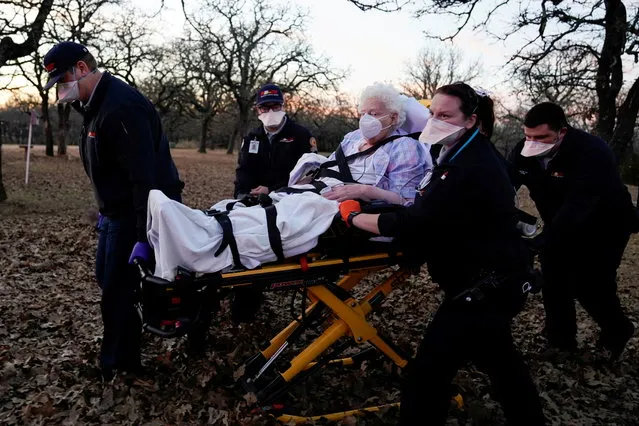 REACT EMS paramedics prepare to transport an 87-yearold woman who had been exposed to the coronavirus disease (COVID-19) and was experiencing symptoms in Meeker, Oklahoma, U.S. December 20, 2020. (Photo by Nick Oxford/Reuters)