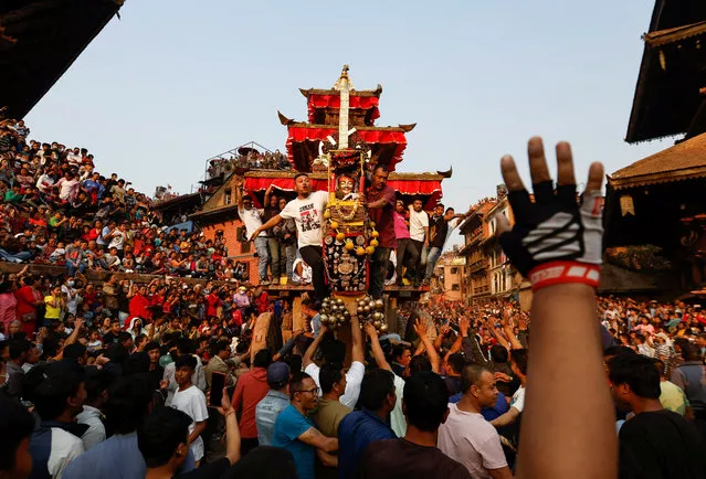 Devotees pull the chariot of God Bhairab through the city center during the Biska festival in Bhaktapur, Nepal on April 10, 2023. (Photo by Navesh Chitrakar/Reuters)