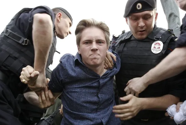 Interior Ministry officers detain an opposition activist during a protest rally to defend Article 31 of the Russian constitution, which guarantees the right of assembly, in Moscow May 31, 2013. (Photo by Sergei Karpukhin/Reuters)
