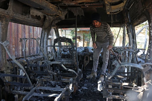 A Palestinian man inspects a vehicle that was damaged following an attack by Israeli settlers in Jabaa village near Bethlehem, in the occupied West Bank on November 18, 2025. Settler violence has surged in recent weeks across the West Bank, drawing international condemnation and even rare criticism from within the Israeli military and government. (Photo by Ahmad Gharabli/AFP Photo)