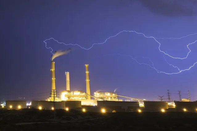 Lightning strikes over a power station during a storm in the city of Ashkelon, Israel October 28, 2015. (Photo by Amir Cohen/Reuters)