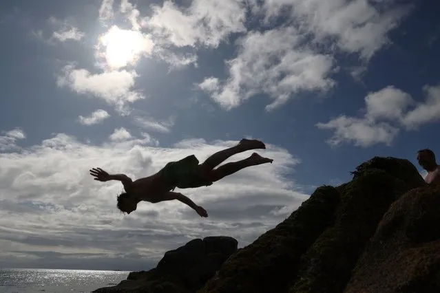 Killian McCullagh from Monkstown diving into the sea at Sandycove, Co.Dublin, Ireland on May 11, 2023. (Photo by Nick Bradshaw/The Irish Times)