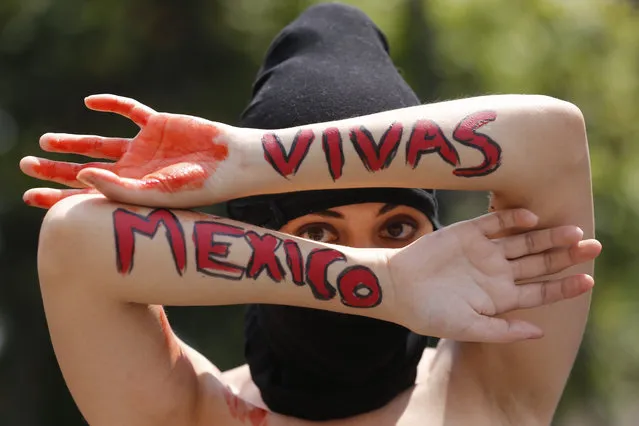 A woman shows her arms with the words “Alive (women)” and “Mexico” as feminists demonstrate against the Government of Andres Manuel Lopez Obrador in the roundabout of Illustrious Jalisco, during the “Anti-Grita de Independencia” (Anti independence cry), event, coinciding with celebrations of the 210th anniversary of the independence of Mexico, in Guadalajara, Jalisco state, Mexico, 16 September 2020. (Photo by Francisco Guasco/EPA/EFE)