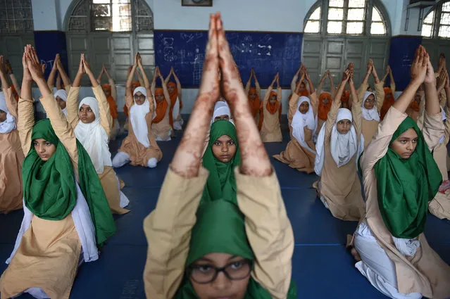 Indian students from Anjuman-E-Islam school participate in a Yoga rehearsal ahead of World Yoga Day in Ahmedabad, India on June 19, 2018. World Yoga Day is observed across the globe on June 21. (Photo by Sam Panthaky/AFP Photo)