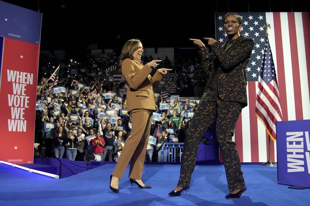 Democratic presidential nominee Vice President Kamala Harris, left, and former first lady Michelle Obama arrive to speak during a campaign rally at the Wings Event Center in Kalamazoo, Mich. on October 26, 2024. (Photo by Jacquelyn Martin/AP Photo)