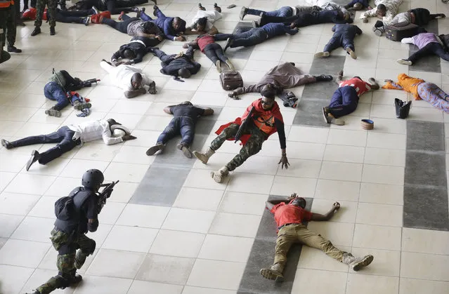 In this Tuesday, November 8, 2016 photo, Nigeria air force special unit simulate during a counter- terrorism exercise, at the departure hall of the Murtala Muhammed International Airport in Lagos, Nigeria. (Photo by Sunday Alamba/AP Photo)