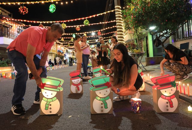 People light candles during the Day of the Little Candles (“Dia de las velitas”) in Envigado, Antioquia department, Colombia, on December 7, 2024. The Day of the Little Candles is a traditional Colombian celebration of the Immaculate Conception of the Virgin Mary, marking the beginning of the Christmas season. (Photo by Jaime Saldarriaga/AFP Photo)