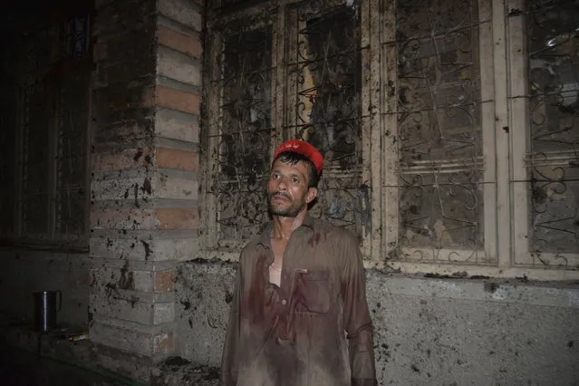 A Pakistani political worker stands at a site of blast in Peshawar, Pakistan, Tuesday, July 10, 2018. (Photo by Muhammad Sajjad/AP Photo)