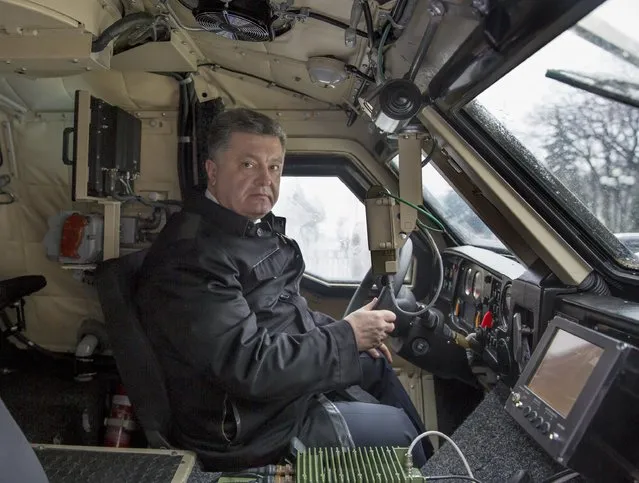 Ukraine's President Petro Poroshenko sits in the driver's seat of an armoured vehicle in Kiev, January 30, 2015, in this handout courtesy of the Ukrainian Presidential Press Service. (Photo by Mykola Lazarenko/Reuters/Ukrainian Presidential Press Service)
