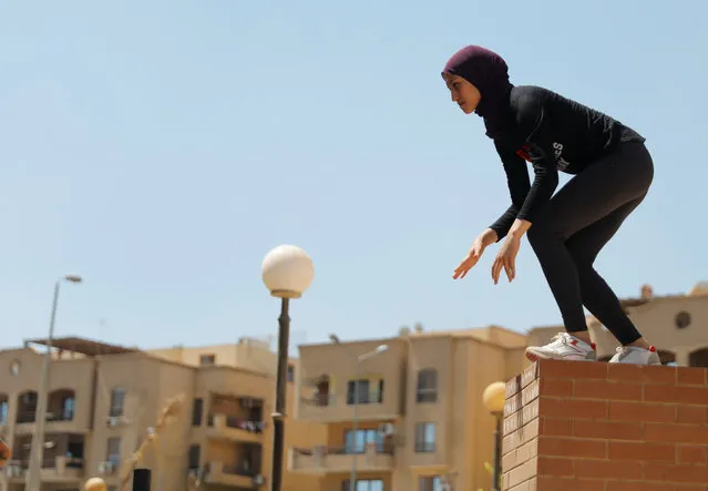 An Egyptian woman from Parkour Egypt “PKE” practices her parkour skills around buildings on the outskirts of Cairo, Egypt on July 20, 2018. Parkour is played by men in Egypt but the sport is neglected and has no regulatory body. Parkour Egypt, a group that comprises men and women, has grown exponentially after starting off with a handful of players. (Photo by Amr Abdallah Dalsh/Reuters)