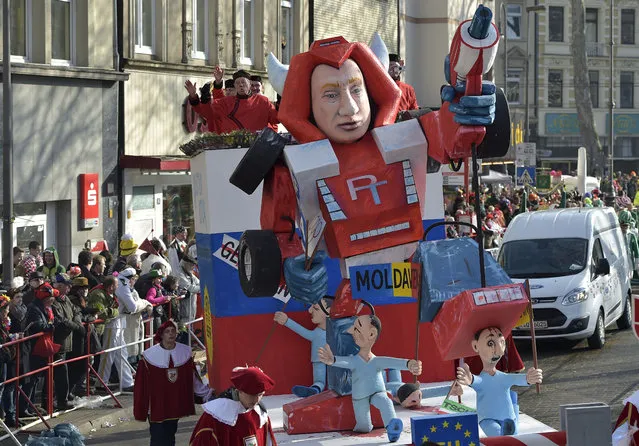 A carnival float depicts Russia's president Putin as a robot out of control named Putinator, during the traditional carnival parade in Cologne, western Germany, Monday, February 16, 2015. (Photo by Martin Meissner/AP Photo)