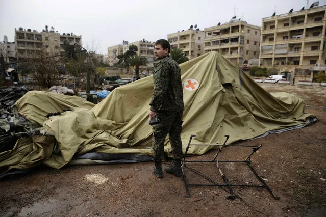 A Russian soldier checks a burned medical tent after rebels launched a mortar shell at a field hospital in west Aleppo, Syria, Monday, December 5, 2016. Rebel shelling of the government-held part of Syria's Aleppo city Monday killed a Russian female nurse in a makeshift Russian hospital in the city, a Russian officer there said. (Photo by Hassan Ammar/AP Photo)